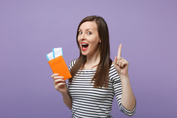Traveler tourist woman girl in casual striped clothes posing isolated on violet purple background studio portrait. Passenger traveling abroad to travel on weekends getaway. Air flight journey concept.