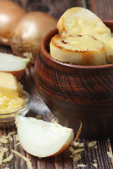 A ceramic pot with French onion soup