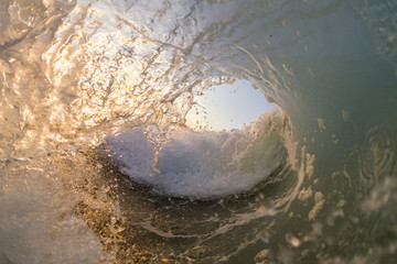 inside view of a wave at sunset