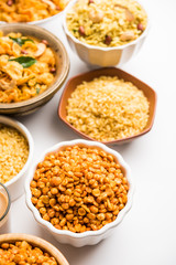 Group of Cornflake and Thick Poha Chivda or Chiwda and Chatpata Masala chana and fried crispy Moong Dal, served in a bowl. selective focus