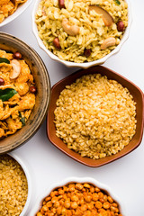 Group of Cornflake and Thick Poha Chivda or Chiwda and Chatpata Masala chana and fried crispy Moong Dal, served in a bowl. selective focus