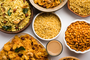 Group of Cornflake and Thick Poha Chivda or Chiwda and Chatpata Masala chana and fried crispy Moong Dal, served in a bowl. selective focus