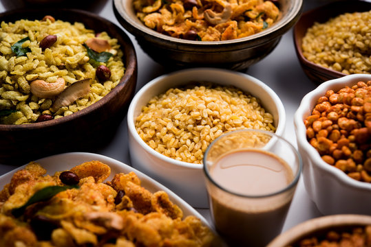 Group of Cornflake and Thick Poha Chivda or Chiwda and Chatpata Masala chana and fried crispy Moong Dal, served in a bowl. selective focus
