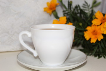 Obraz na płótnie Canvas Delicious tea in a white Cup on a saucer.