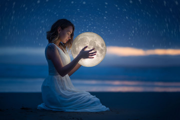 Delicate photography, Astrology, Women's magic. Beautiful attractive girl on a night beach with...