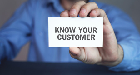 Businessman holding Know Your Customer on business card.