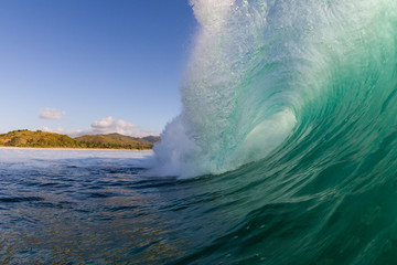 perfect barrelling wave crashing on a reef