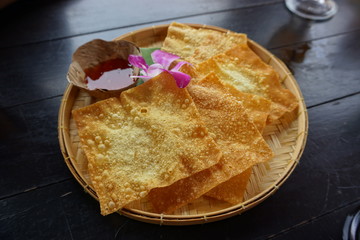Thai fried wonton in a tray made from bamboo