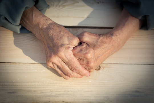Hands of an elderly person. The concept of lonely old age, sadness and past tense, help and care older people. Image.