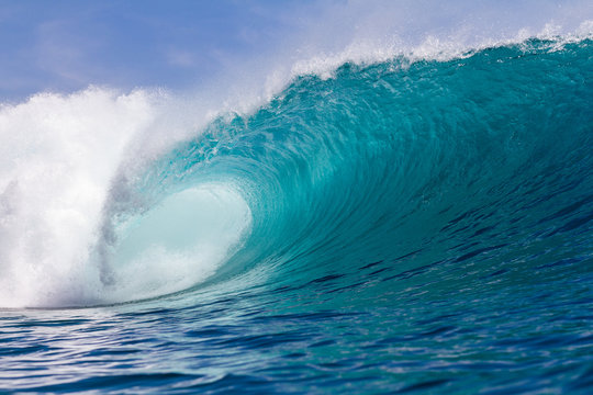 perfect turquoise wave breaking on a coral reef