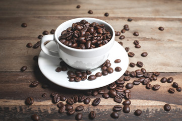 The coffee beans that were placed in that coffee cup on an old wooden table