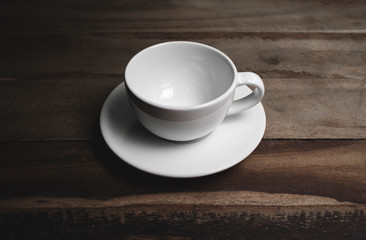 Obraz na płótnie Canvas An empty coffee cup on an old wooden table