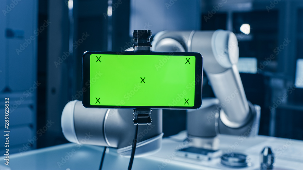 Poster Robot Arm Holding Green Mock-up Screen Smartphone in Landscape Mode. Industrial Robotic Manipulator End Effector Holds Mobile Phone with Chroma Key Display. 