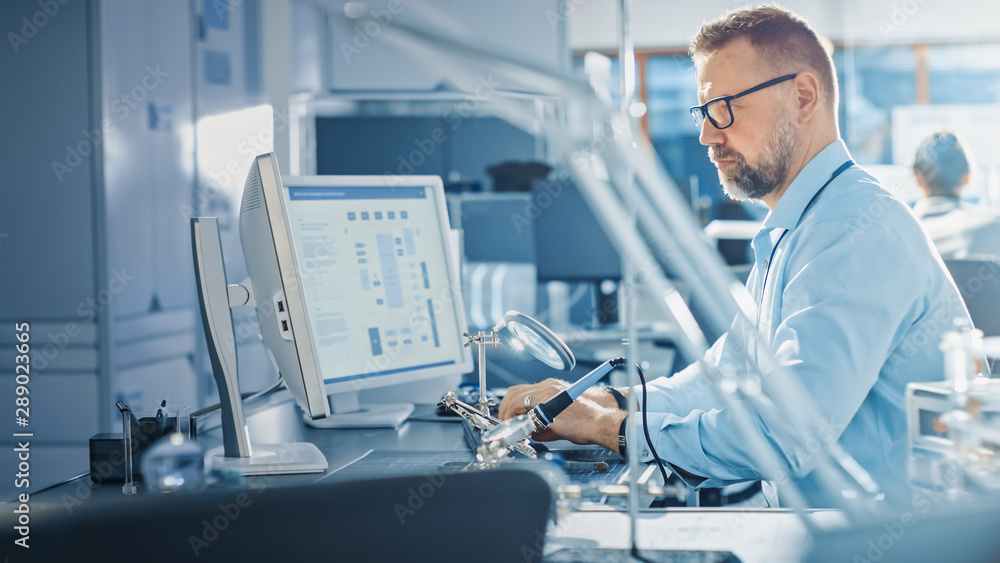 Poster Electronics Development Engineer Working on Computer, Designing Motherboard, Doing Maintenance of Devices and Soldering Circuit Boards. Professional working in Bright and Modern Office 