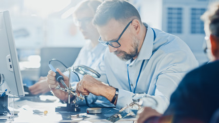 Team of Electronics Development Engineers Working on Computers, Designing Motherboard, Doing...