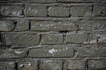 Texture of an old paint covered brick wall. Background image of an abandoned brick wall with painted over paint
