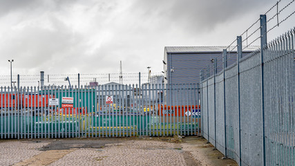 Great Yarmouth, Norfolk, UK – September 08 2019. Metal security fence around the perimeter of an industrial unit in the Southtown Road region of Great Yarmouth - obrazy, fototapety, plakaty