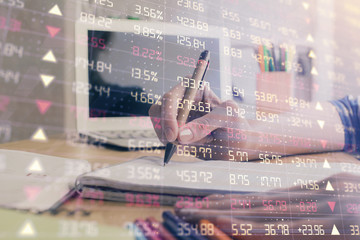 Financial forex charts displayed on woman's hand taking notes background. Concept of research. Double exposure