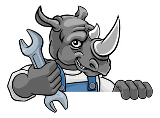 A rhino cartoon animal mascot plumber, mechanic or handyman builder construction maintenance contractor peeking around a sign holding a spanner or wrench