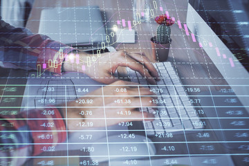 Double exposure of stock market chart with man working on computer on background. Concept of financial analysis.