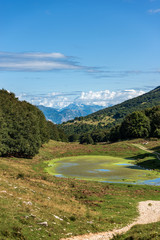 Small lake for livestock in a valley of the Italian Alps. Monte Baldo near Verona and lake Garda, Veneto, Italy, south Europe