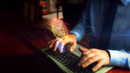 Man typing on keyboard with bulb symbol hologram