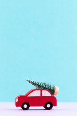 Christmas car on pastel color background. Christmas or New Year minimal concept.