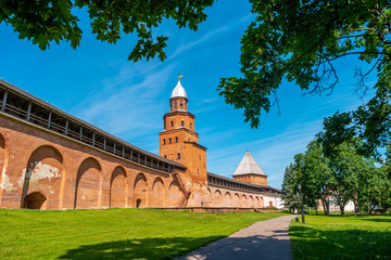 Fototapeta na wymiar Veliky Novgorod, Russia. View of Kremlin wall and Kokui Tower with green trees at summer day.