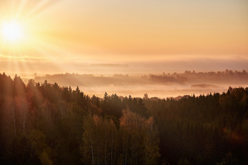 Morning landspace with sun rays. Beautiful landscape with forest and fog.Lithuanian landscape.