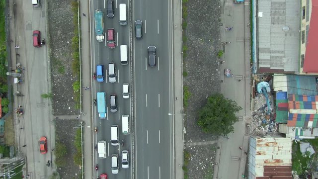 Top down aerial view of highway having traffic at the middle roadway due to rush hour