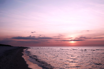 Obraz premium purple and orange sunset at beach at Baltic Sea, Poland
