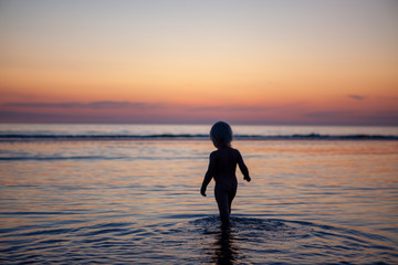 child silhouette in water