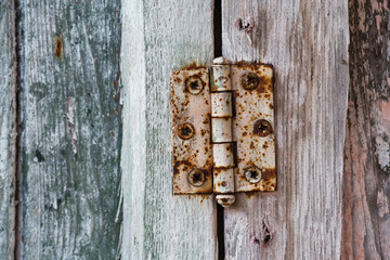 Vintage door hinge. Old metal rusty door hinge. Hardware close-up. White background.