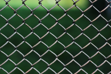 Fototapeta premium Chain link fence. Metal mesh fence closeup photo background. Fence chain texture