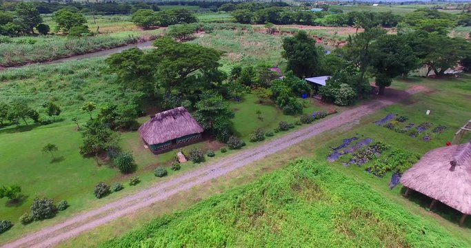 Aerial Traditional Fijian thatched Bure and River in valley