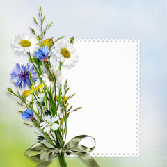 Fototapeta na wymiar Beautiful vintage background with a bouquet of daisies and cornflowers with a card for text or photo
