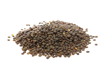 Macro image of brown lentils pile isolated at white background.