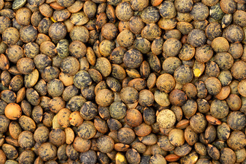 Top view macro image of brown lentils as a natural healthy food background.
