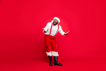 Fototapeta na wymiar Full length photo of funky hipster afro american santa having xmas cap screaming wearing pants trousers isolated over red background