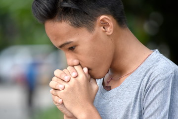 A Praying Asian Boy Teenager