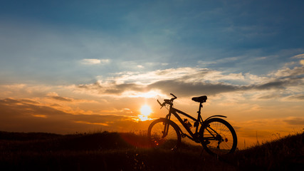 Fototapeta na wymiar Mountain bike on the background of sunset.