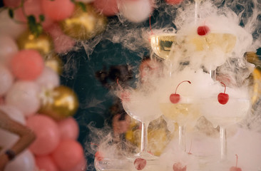 a pyramid of glass goblets into which champagne is poured