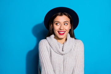 Pretty lady looking empty space cheerful laughing wear warm knitted pullover isolated blue background