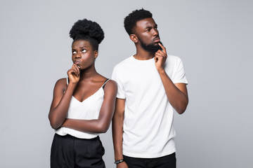Beautiful African couple looking at the camera with unhappy offended expression, not speaking to...