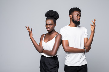 Beautiful African couple looking at the camera with unhappy offended expression, not speaking to...