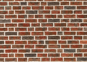 Old abandoned brick wall of red spotted damaged brick with a white cement seam. Abstract modern creative textured background