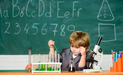 school kid scientist studying science. Little kid learning chemistry in school laboratory. Little boy at the elementary school. Biology lab equipment. little boy at lesson. Back to school