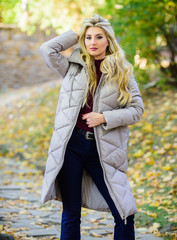 How to rock puffer jacket like star. Puffer fashion trend concept. Girl fashionable blonde walk in...