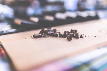 Pile chopped, milled chocolate shavings on cutting board.