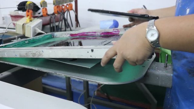 Hand pressing silk-screen printing, close up view.